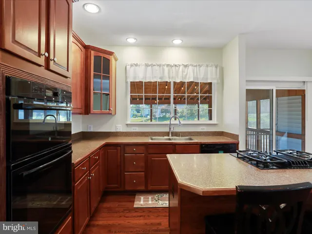 a view of empty room with wooden floor and fireplace