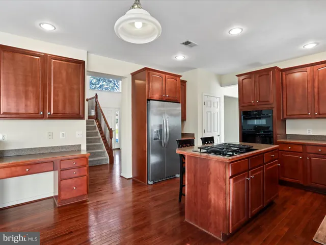 a kitchen with a stove a refrigerator and a sink