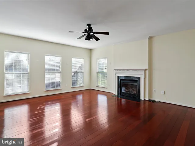 a view of a room with wooden floor and windows
