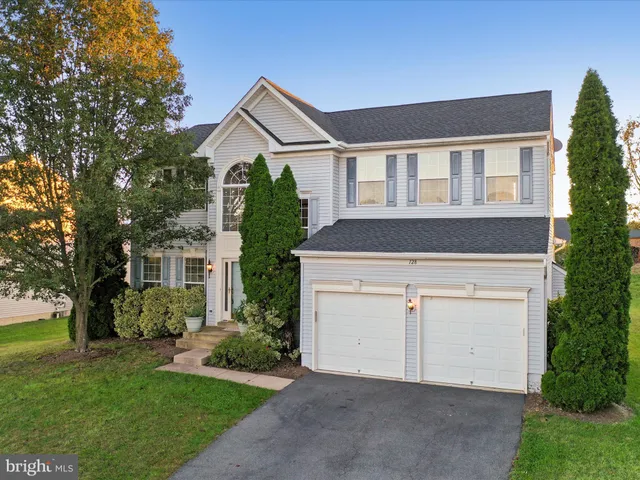 a view of a room with chandelier fan and windows