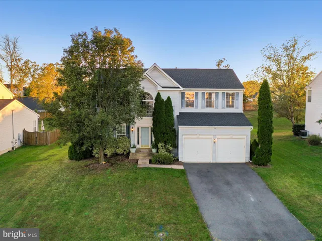 a bedroom with a bed chandelier and couch