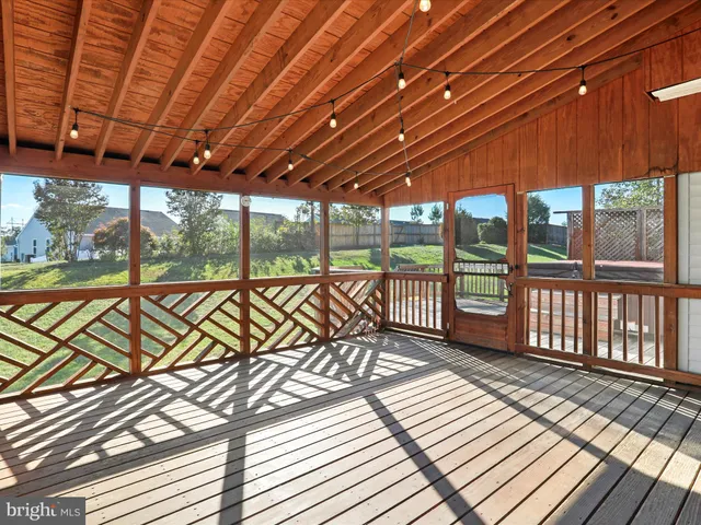a kitchen with a table chairs stove and wooden floor