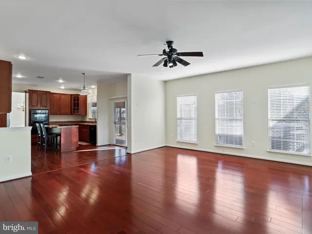 a view of empty room with wooden floor and fireplace