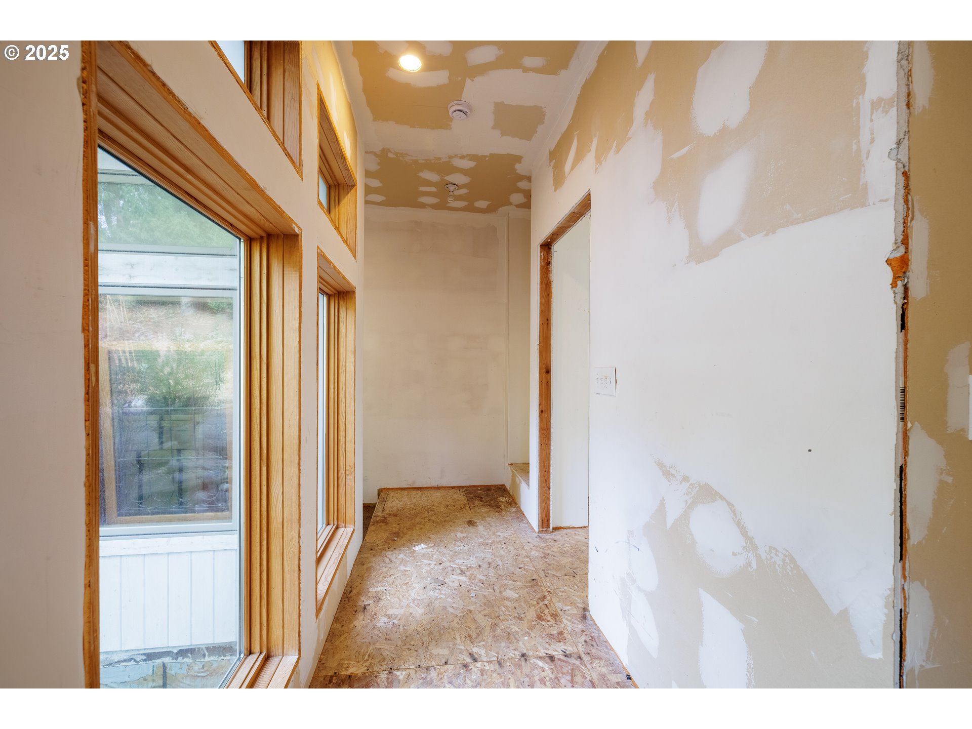 2770 Agate Street Eugene, OR 97403 - Photo 32 of 42 a view of a hallway with wooden floor and a bathroom