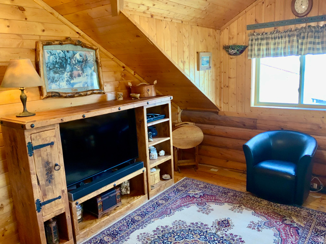 76 Highway 118 Monroe, UT 84754 - Photo 45 of 76 Living area featuring vaulted ceiling, wood walls, wooden ceiling, and hardwood / wood-style floors