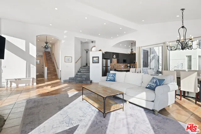 a living room with furniture and kitchen view