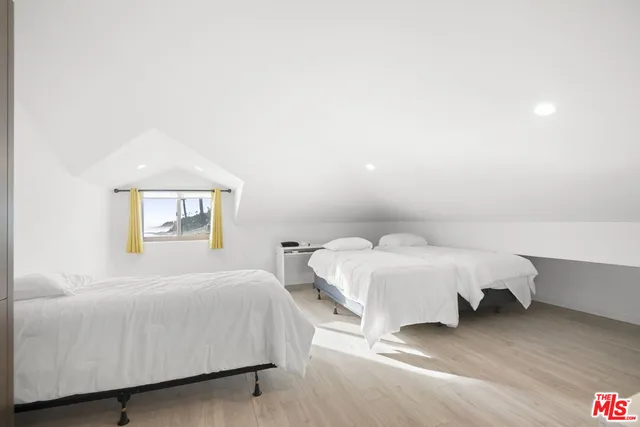 a bedroom with a bed and a night stand