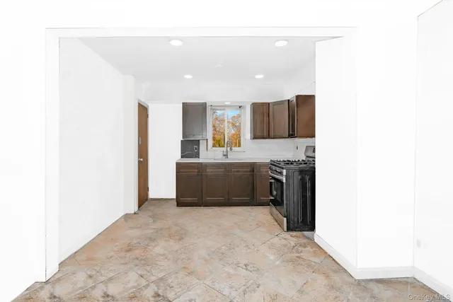 a large kitchen with a sink and cabinets