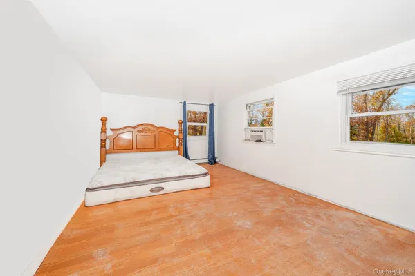 a bedroom with a bed and window