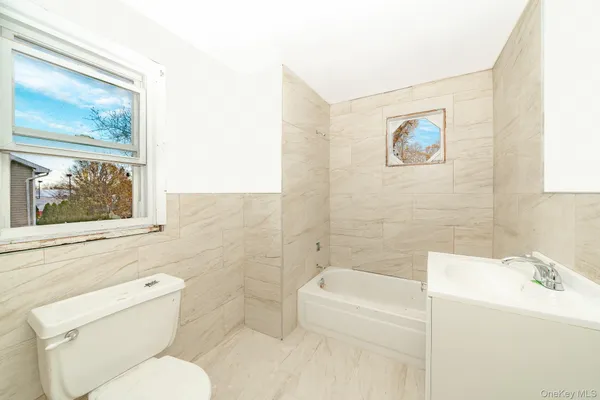 a bathroom with a toilet a sink and bathtub