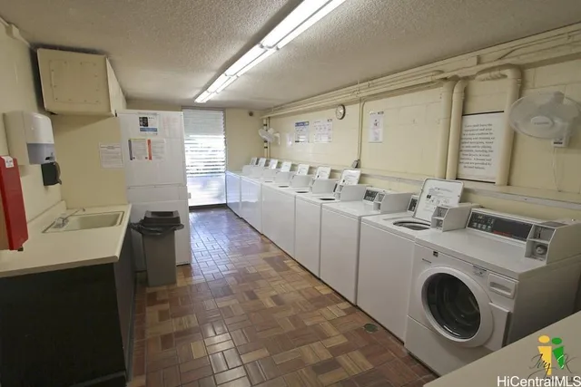 a view of a sink and washer dryer