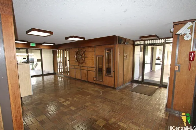 a view of a hallway with floor to ceiling window and wooden floor