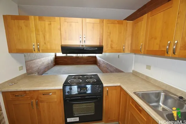 a kitchen with a sink stove and cabinets