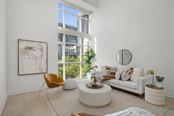 a living room with furniture and a floor to ceiling window