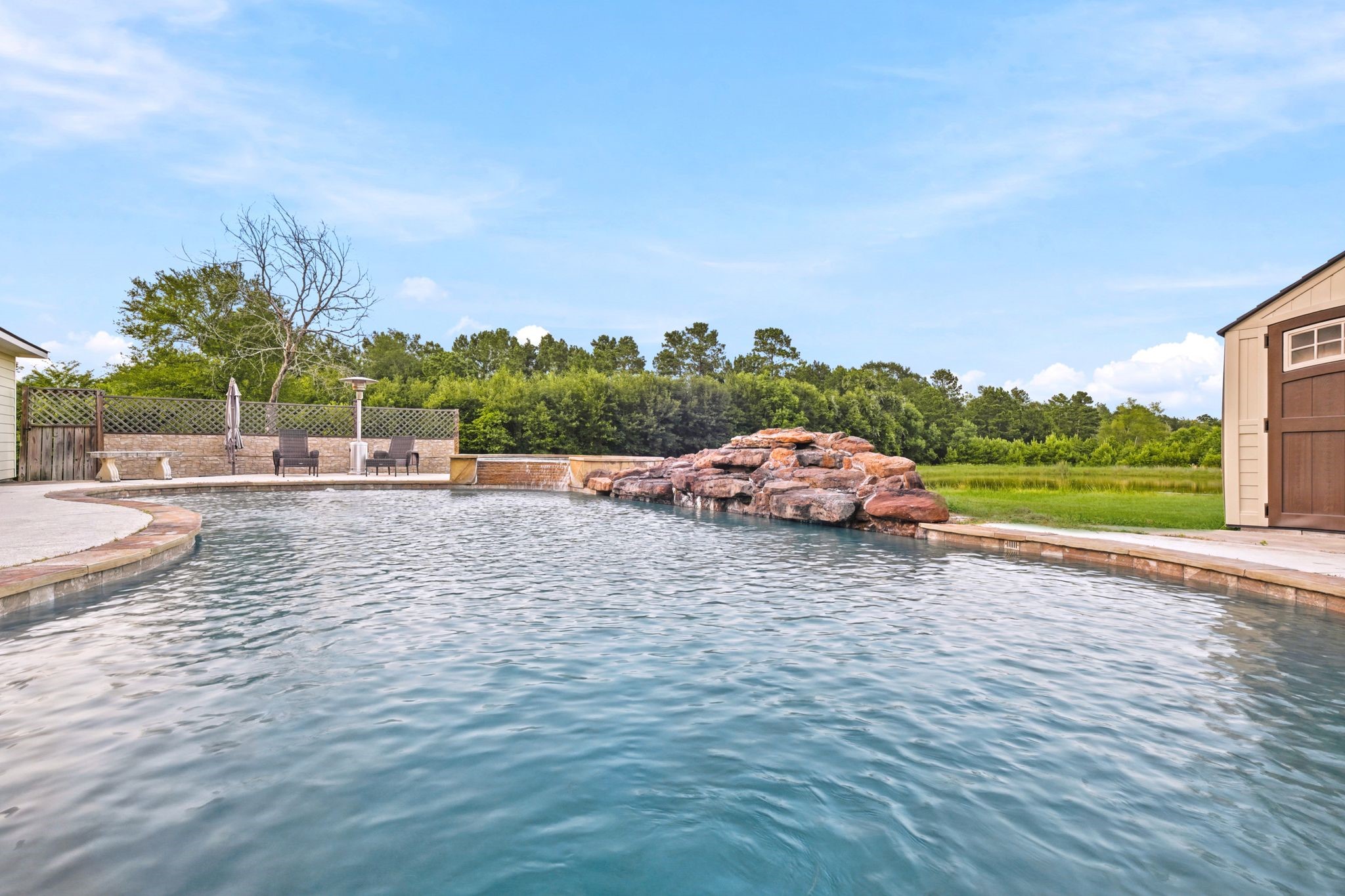 144 Wood Farm Road Huntsville, TX 77320 - Photo 39 of 50 a white house with a yard and ocean view