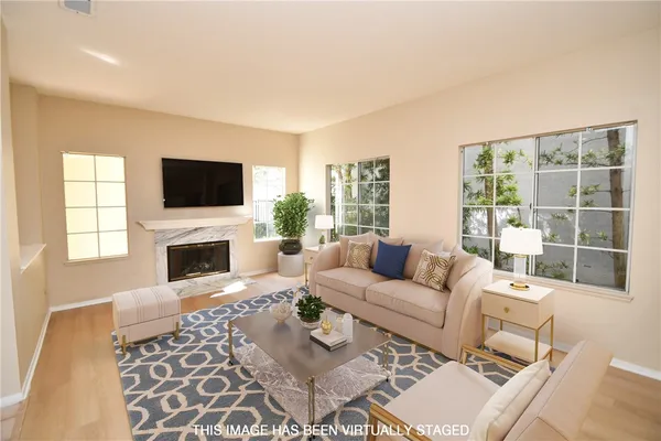 a living room with furniture a fireplace and a flat screen tv
