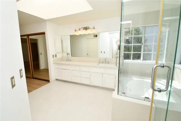 a bathroom with a tub sink and mirror