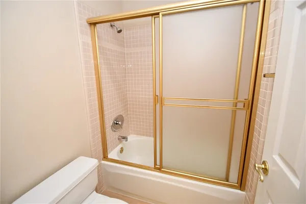 a bathroom with a shower and a toilet