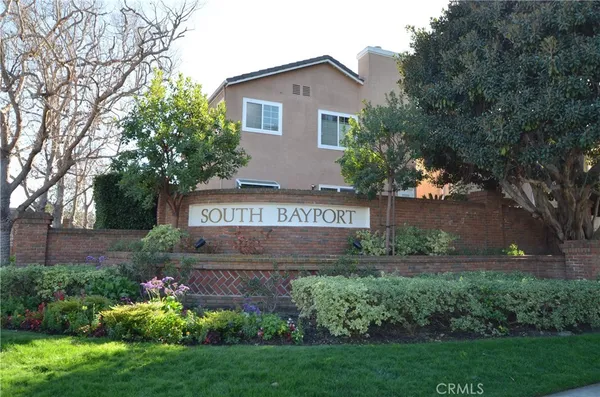 a view of sign board with flower around