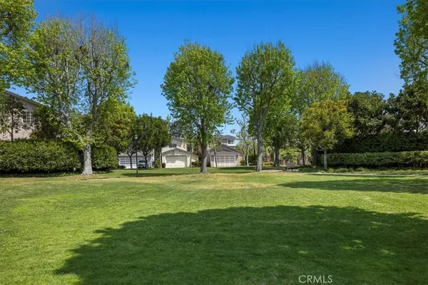 a grassy field with trees in the background