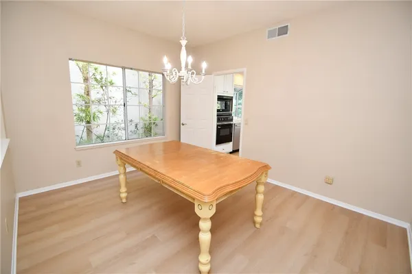 a room with pool table and windows