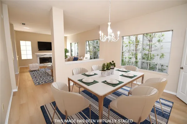 a view of a dining room with furniture wooden floor and chandelier