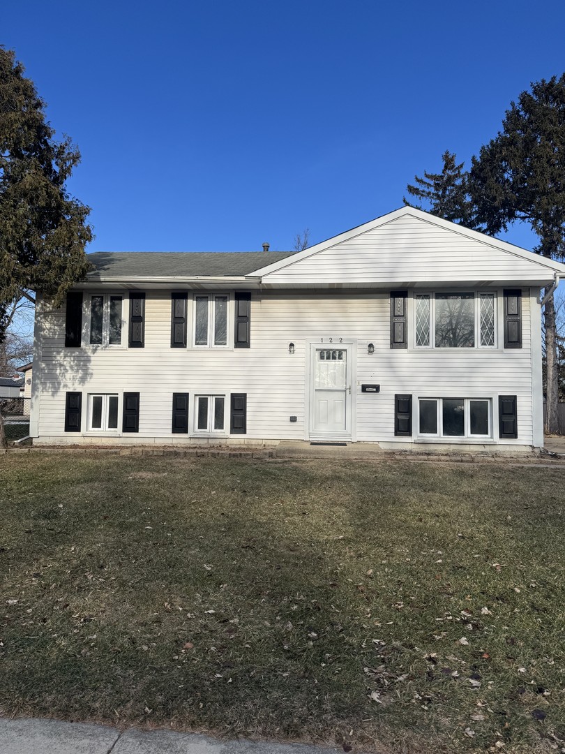 122 Ambassador Avenue Romeoville, IL 60446 - Photo 1 of 7 a front view of a house with a garden