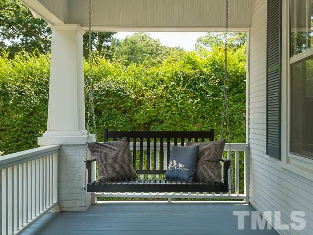 115 Hudson Street Raleigh, NC 27608 - Photo 5 of 25 a balcony with a bench