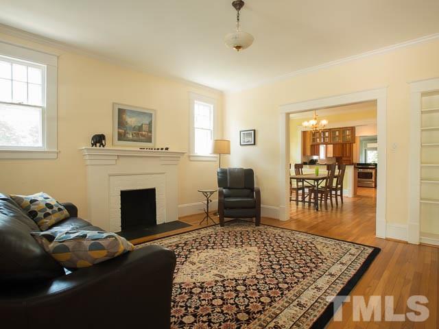 115 Hudson Street Raleigh, NC 27608 - Photo 6 of 25 a living room with furniture and a fireplace