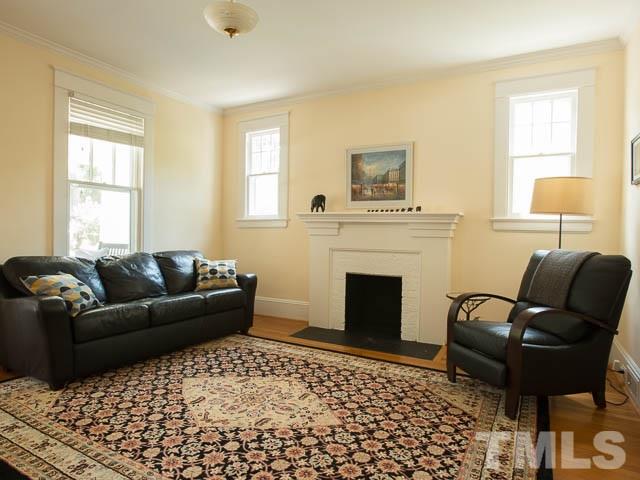 115 Hudson Street Raleigh, NC 27608 - Photo 7 of 25 a living room with furniture and a fireplace