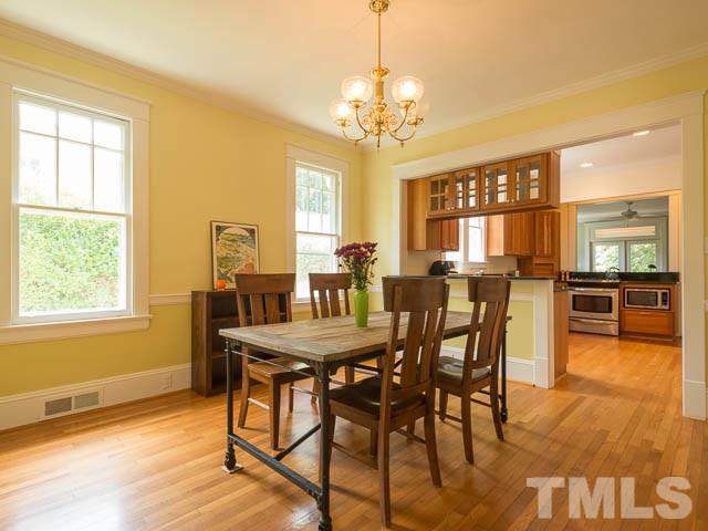 115 Hudson Street Raleigh, NC 27608 - Photo 8 of 25 a view of a dining room with furniture window and wooden floor