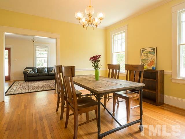 115 Hudson Street Raleigh, NC 27608 - Photo 9 of 25 a view of a dining room with furniture and a chandelier