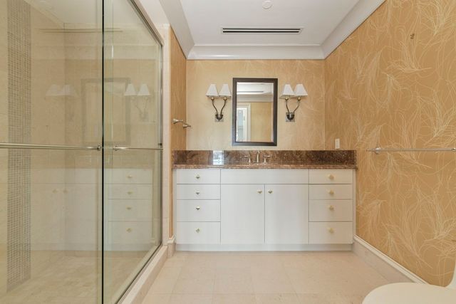 a bathroom with a granite countertop sink a mirror and a bathtub