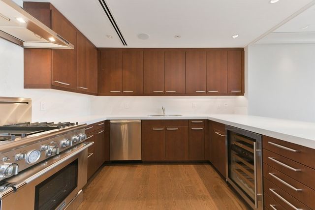 a kitchen with a sink stove and cabinets