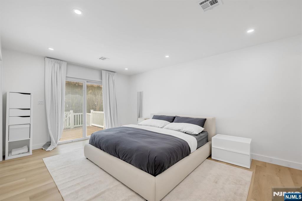 123 Chestnut Street Garfield, NJ 07026 - Photo 11 of 27 a spacious bedroom with a bed and a cabinets