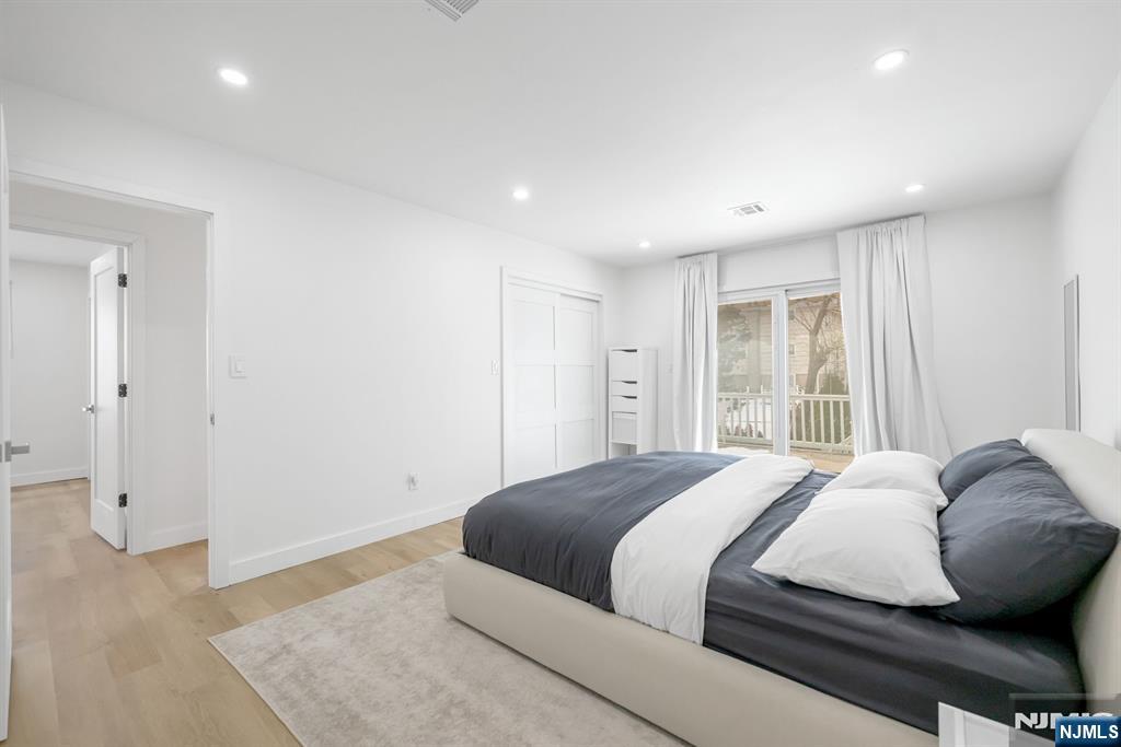 123 Chestnut Street Garfield, NJ 07026 - Photo 12 of 27 a bedroom with a large bed and wooden floor