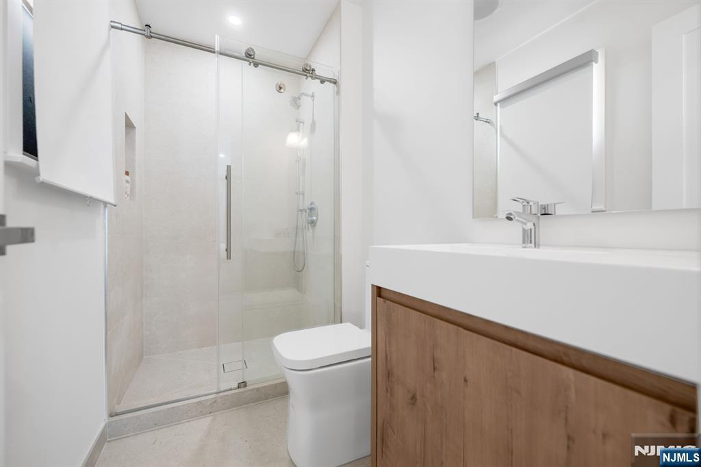 123 Chestnut Street Garfield, NJ 07026 - Photo 13 of 27 a bathroom with a sink a toilet and shower