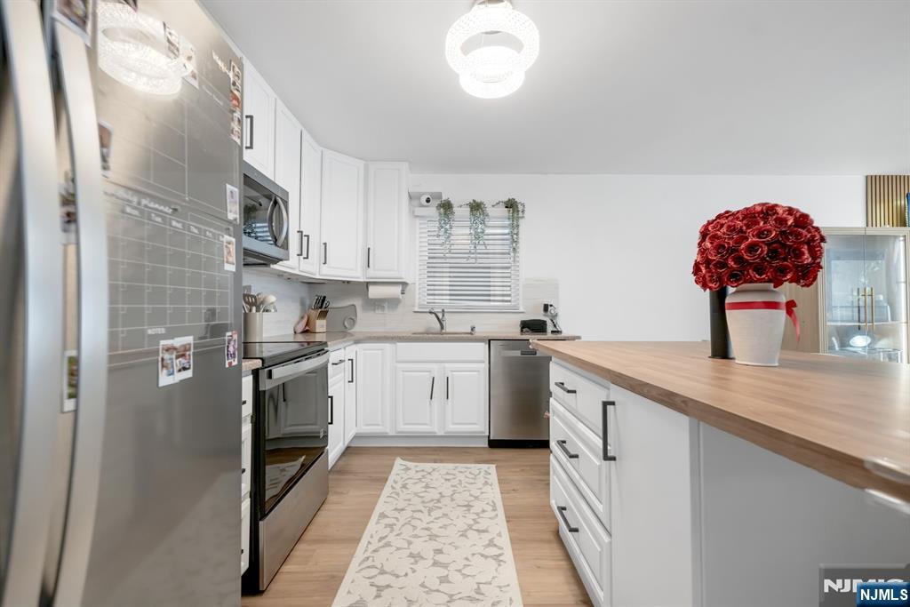 123 Chestnut Street Garfield, NJ 07026 - Photo 20 of 27 a kitchen with granite countertop a sink stainless steel appliances and cabinets