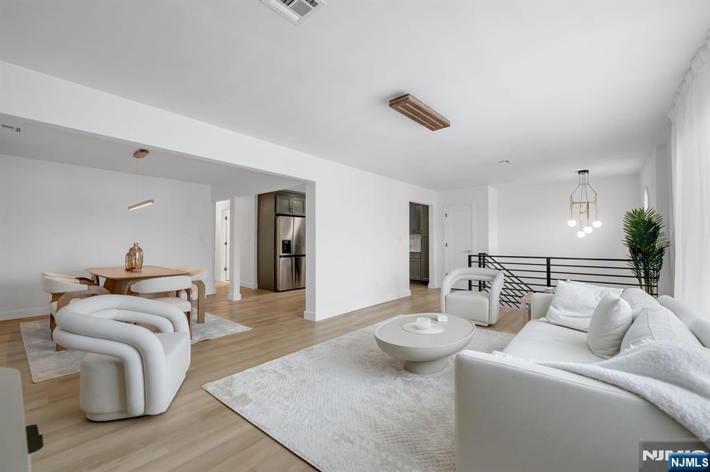 123 Chestnut Street Garfield, NJ 07026 - Photo 3 of 27 a living room with furniture and a wooden floor