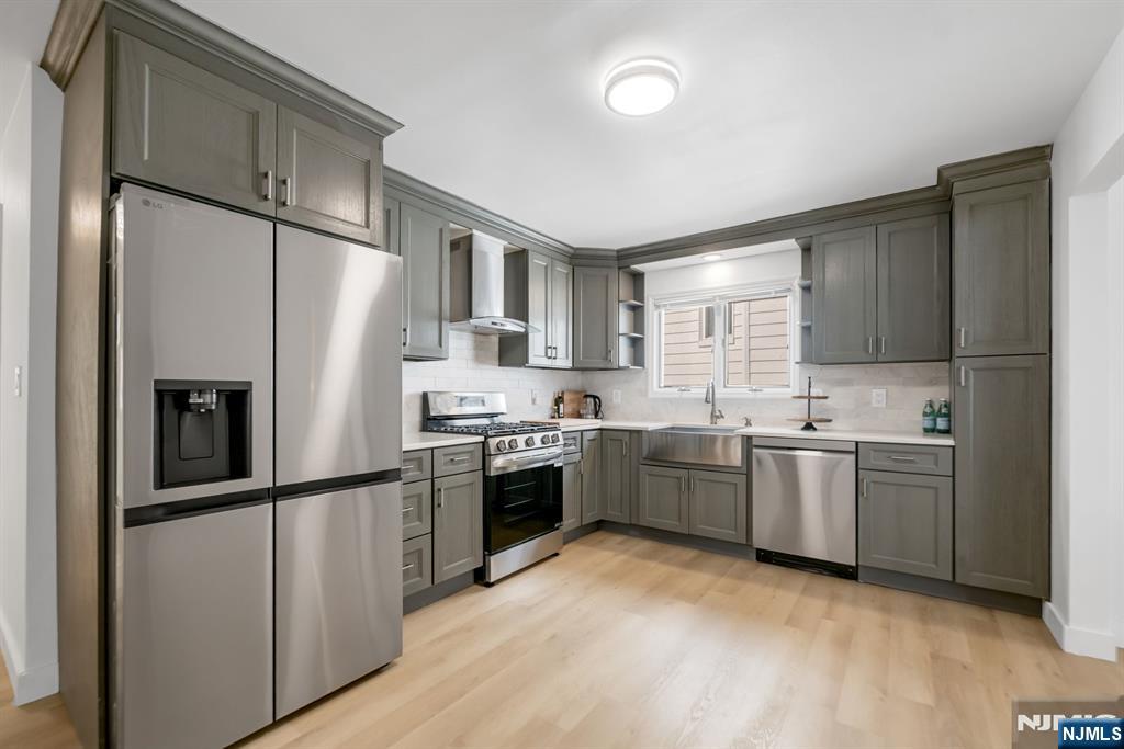 123 Chestnut Street Garfield, NJ 07026 - Photo 6 of 27 a kitchen with granite countertop a refrigerator stove top oven and sink