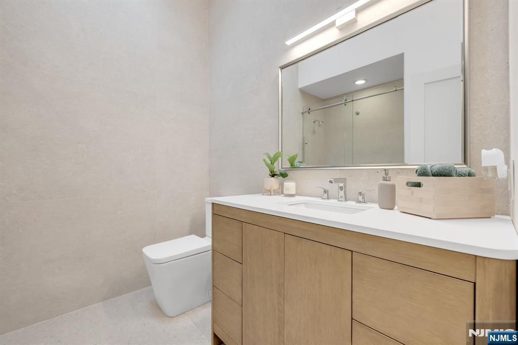 123 Chestnut Street Garfield, NJ 07026 - Photo 9 of 27 a bathroom with a granite countertop sink and a mirror