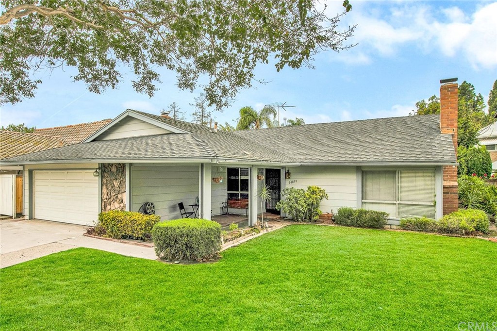 14891 Featherhill Road Tustin, CA 92780 - Photo 1 of 1 a front view of a house with a yard and garage