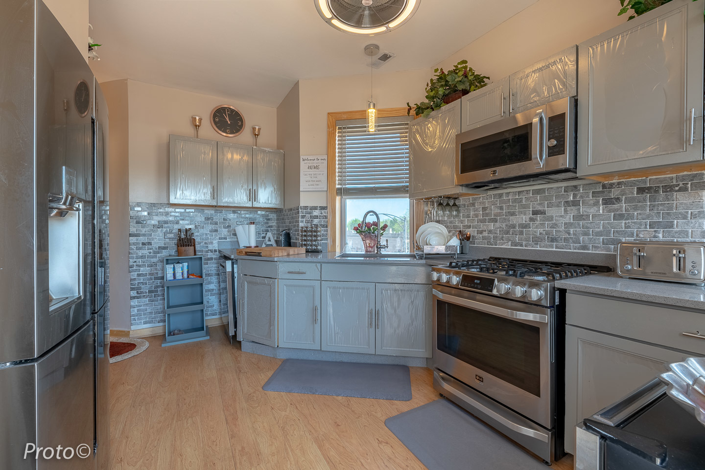 3605 West Cermak Road Chicago, IL 60623 - Photo 19 of 41 a kitchen with stainless steel appliances a stove a sink and a microwave