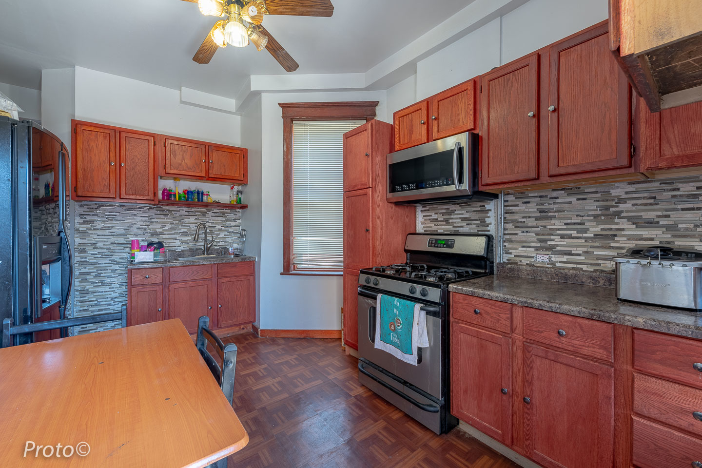 3605 West Cermak Road Chicago, IL 60623 - Photo 22 of 41 a kitchen with stainless steel appliances granite countertop wooden cabinets a stove a sink and dishwasher