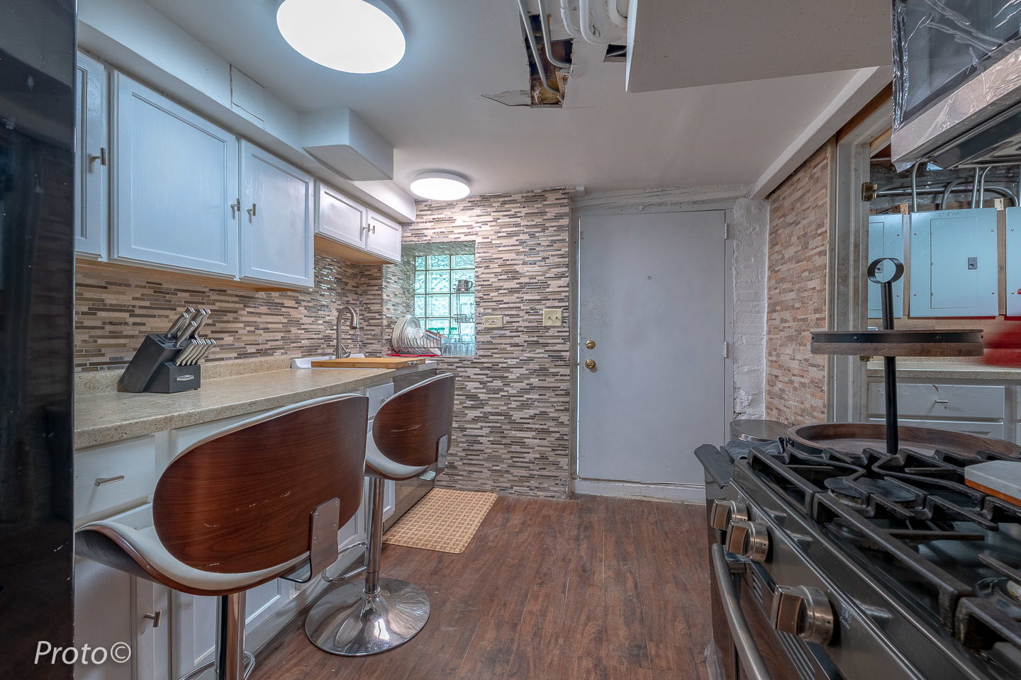 3605 West Cermak Road Chicago, IL 60623 - Photo 32 of 41 a kitchen with a stove and a wooden floor
