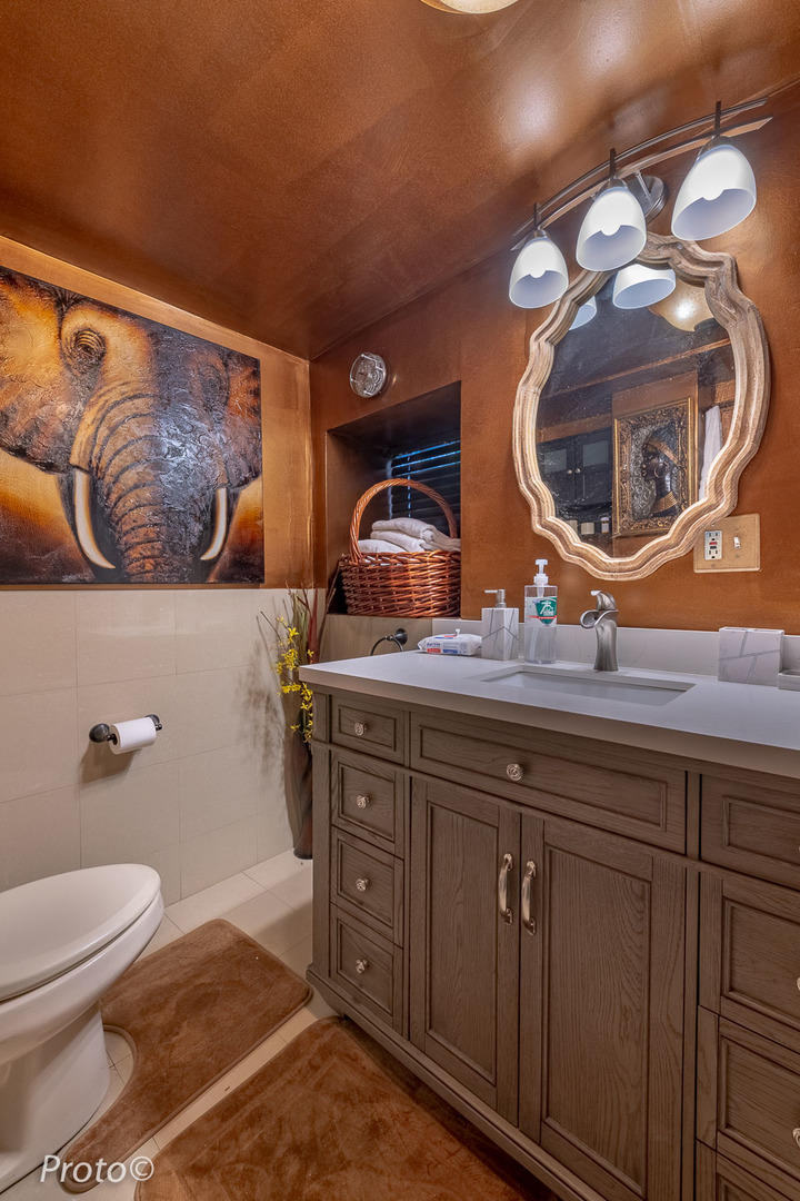 3605 West Cermak Road Chicago, IL 60623 - Photo 34 of 41 a bathroom with a toilet and mirror