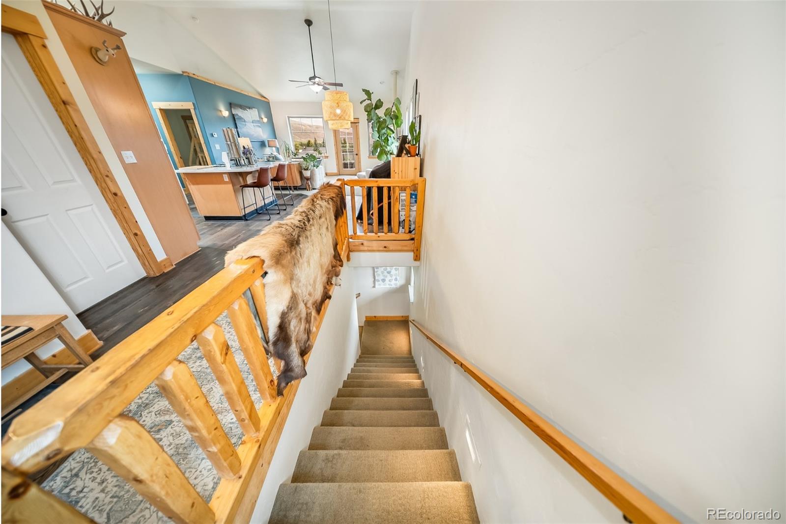 143 East Grand Avenue Hot Sulphur Springs, CO 80451 - Photo 20 of 37 a view of a hallway with wooden floor and staircase