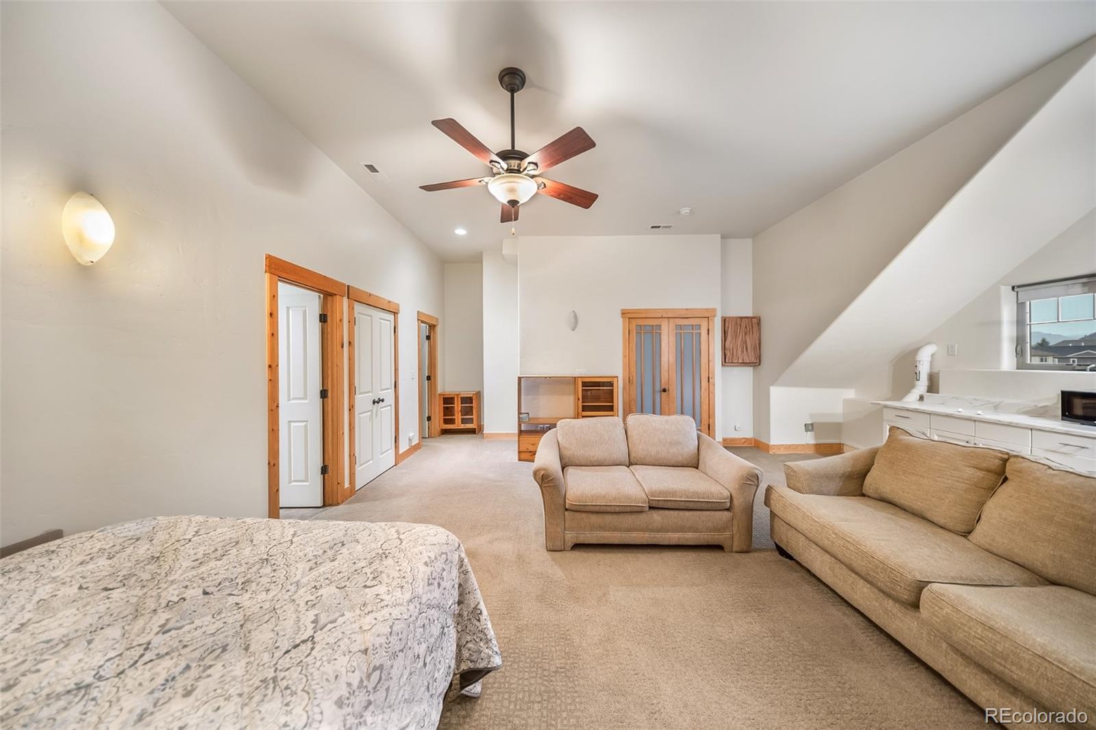 143 East Grand Avenue Hot Sulphur Springs, CO 80451 - Photo 23 of 37 a living room with furniture ceiling fan and a wooden floor
