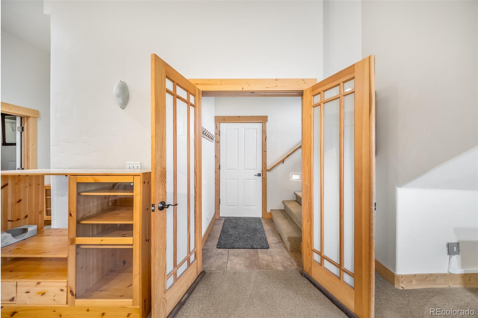 143 East Grand Avenue Hot Sulphur Springs, CO 80451 - Photo 26 of 37 a view of a hallway with wooden floor and staircase
