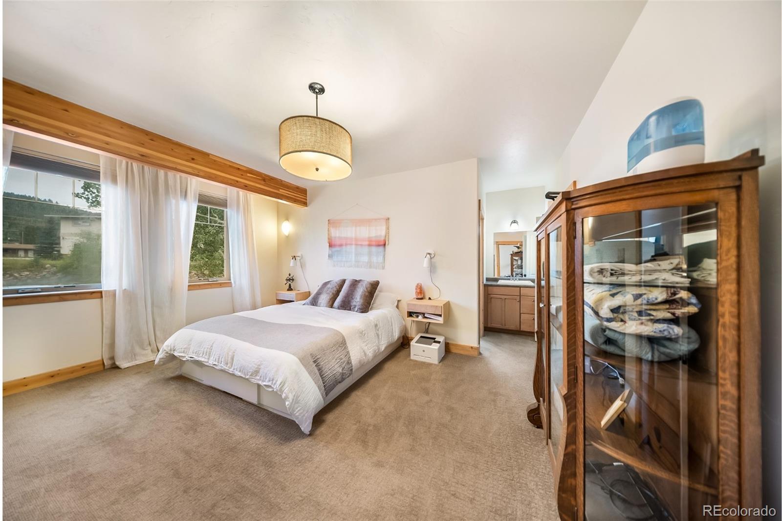 143 East Grand Avenue Hot Sulphur Springs, CO 80451 - Photo 10 of 37 a spacious bedroom with a bed and a large mirror